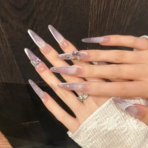 Handmade long stiletto press-on nails with purple cat-eye gradient and crystal rhinestones
