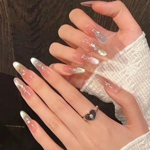 Pink cat-eye gradient press-on nails in long almond shape with glitter accents