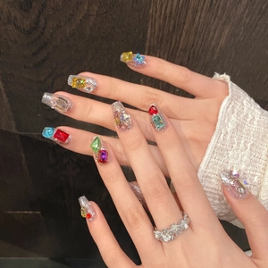 Sparkly handmade press-on nails with colorful rhinestones and silver glitter finish