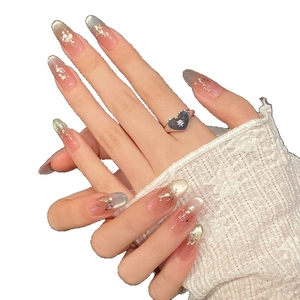 Pink and green cat eye press-on nails with glitter on long almond-shaped tips
