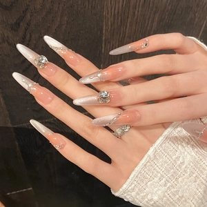 Handmade long almond cat-eye press-on nails with peach pink gradient and crystals