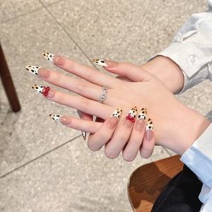 Handmade leopard print press-on nails with 3D red bows and French gradient long stiletto tips