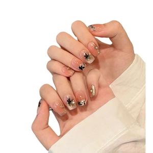 Short square press-on nails with peach gradient, butterfly art, and gold foil accents