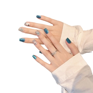 Klein blue cat eye press-on nails with glitter snowflakes and rhinestone accents