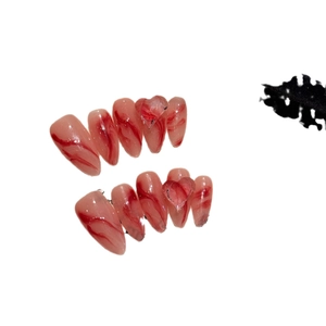 Handmade press-on nails with red marble pattern and clear 3D heart shapes