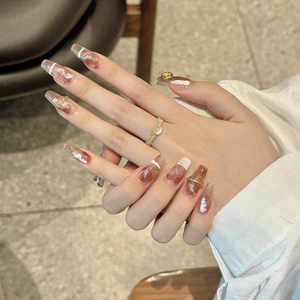 Japanese amber marble press-on nails with white swirls and gold ring accents