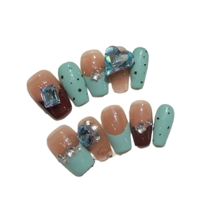 Handmade press-on nail kit with mint green, brown tones and blue heart gemstone accents