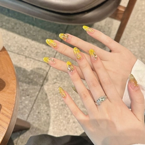 Luxurious long almond press-on nails with cat-eye glitter, gold 3D flowers and rhinestones