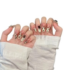 Handmade leopard print almond press-on nails with brown gemstone and gold glitter accents