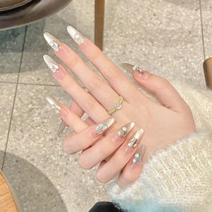 Handmade almond press-on nails with sparkling rhinestones and gradient cream white finish