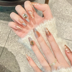 Amber marble press-on nails with cat-eye effect and 3D rhinestones on coffin shape