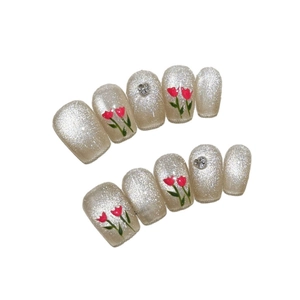 Silver cat eye press-on nails with red tulip art and silver heart charms in 10-piece set