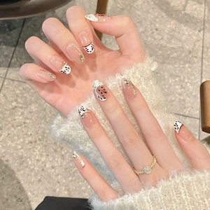 Hand-painted maple leaf press-on nails with French glitter tips and small rhinestones