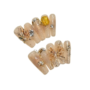 Coffin press-on nails with 3D butterflies and amber rhinestones on nude glitter base