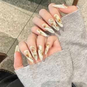 Hand-painted marble pattern press-on nails with gold accents and pearl details