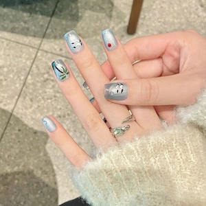 Blue cat-eye press-on nails with palm tree design and silver glitter effect