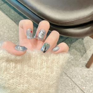 Handmade blue and grey cat eye press-on nails featuring tropical coconut tree hand-painted art