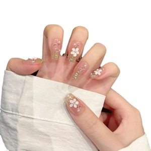Elegant cat-eye press-on nails with white floral 3D art and pearl accents