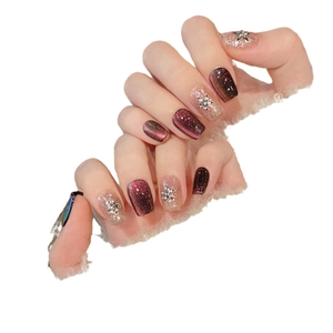 Deep burgundy cat eye press-on nails with silver star charms and champagne glitter