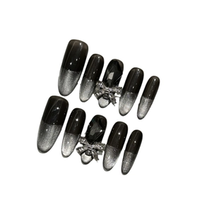 Cyberpunk black and silver gradient press-on nails with 3D gems and metal bow accents
