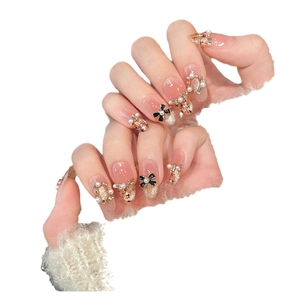 Pink jelly press-on nails with bow, pearls, and classic plaid pattern designs