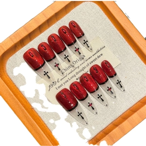 Handmade stiletto press-on nails with red glitter, gothic black crosses and rhinestones