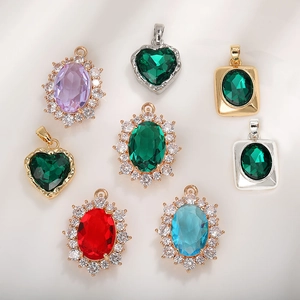 Detail of colorful emerald cut zircon pendants in various geometric shapes and gold frames