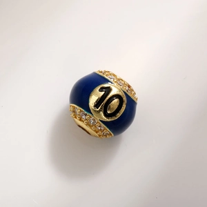 Macro view of blue enamel charm bead featuring number 10 and pavé zircon detailing