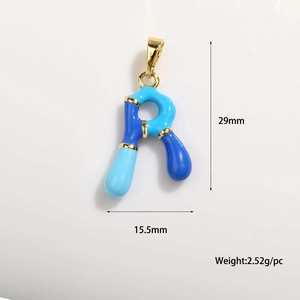Macro detail of enamel letter R charm with dimensions 29mm by 15.5mm in gold plating