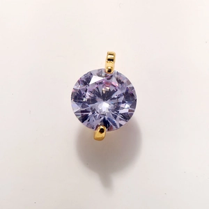Macro shot of purple round-cut zircon pendant with gold-plated double-loop connectors