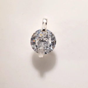 Close-up of hexagonal star pendant with clear gemstone in gold-plated setting