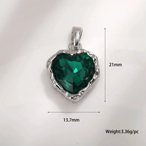 Macro detail of heart-shaped emerald zircon pendant with silver textured edge, 21x13.7mm