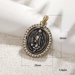 Close-up of a 32mm vintage oval goddess pendant with cubic zirconia and two-tone finish
