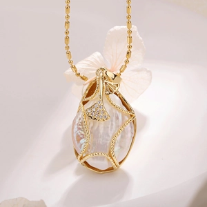 Baroque pearl necklace with gold maple leaf pendant and micro-pave zircons