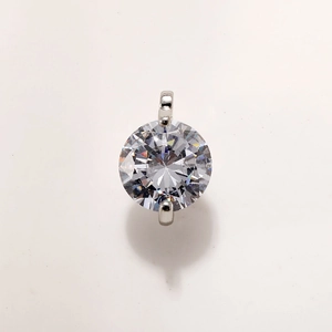 Close-up of a sparkling round-cut crystal pendant in a gold-plated hexagram setting