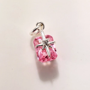 Macro detail of pink crystal rectangle pendant with silver star accent and diamond point