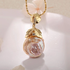 Baroque pearl necklace with gold leaf pendant and iridescent purple metallic luster
