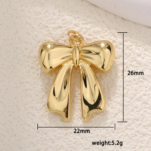 Detail of a gold-plated bow pendant with 26x22mm dimensions and 5.2g weight measurement