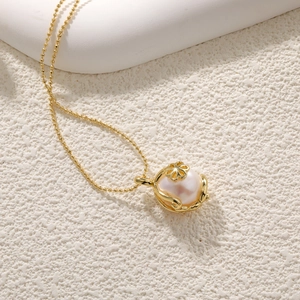 Detail of freshwater pearl pendant with golden flower setting on beaded chain necklace
