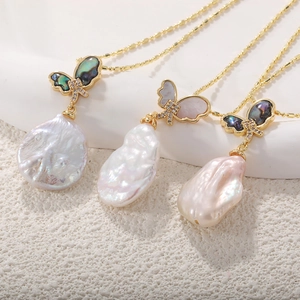 Detailed view of baroque pearl necklaces with butterfly charms in various shell colors
