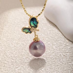 Elegant butterfly necklace with purple pearl and iridescent shell on a golden chain