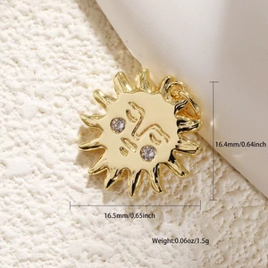 Macro detail of a 16.4mm gold sun pendant with relief face and sparkling zircon eyes