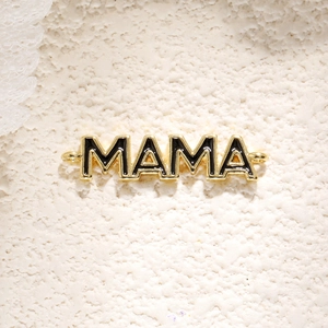 Κοντινό πλάνο χρυσού μενταγιόν MOM με μαύρο σμάλτο και πλαϊνούς κρίκους για DIY κοσμήματα