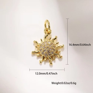 Macro shot of gold sun pendant with cubic zirconia and dimension labels 16.4x12mm