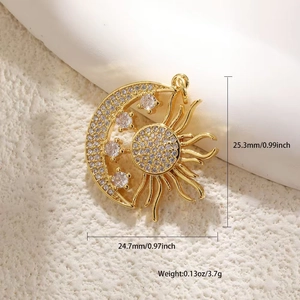 Detail view of gold sun and moon pendant with dimensions 25.3mm by 24.7mm