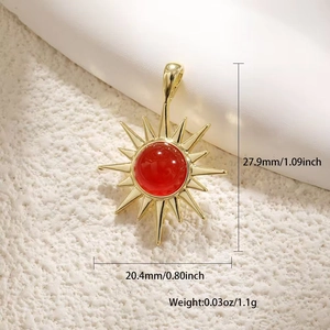 Detail view of gold sunburst pendant with red stone, dimensions 20.4mm x 27.9mm
