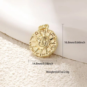 Macro shot of gold sun face pendant with zodiac symbols, size 16.8x14.8mm and 2g weight