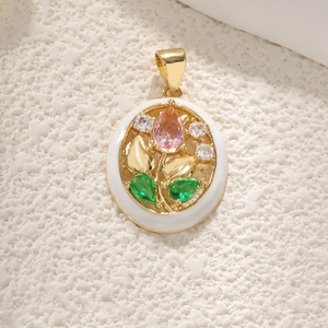 Detail of round gold-plated tulip pendant with pink gems and white enamel petals