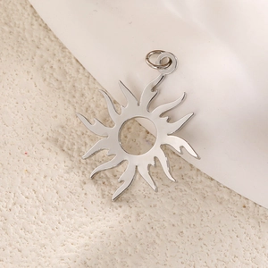Polished silver sun totem pendant with 12 wave rays on a minimalist textured background