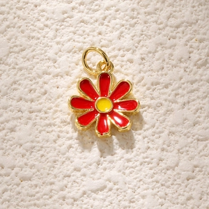 Detailed macro view of red daisy flower charm with gold plating for jewelry DIY